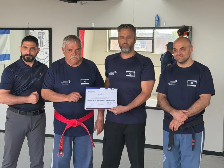 An adult participant receiving a certificate at the gym