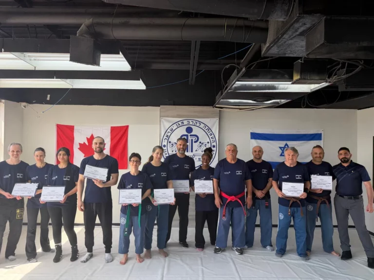 Adult participants holding certificates together at the gym